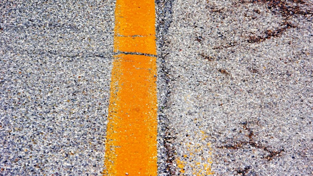 Yellow line marking on the edge of a road